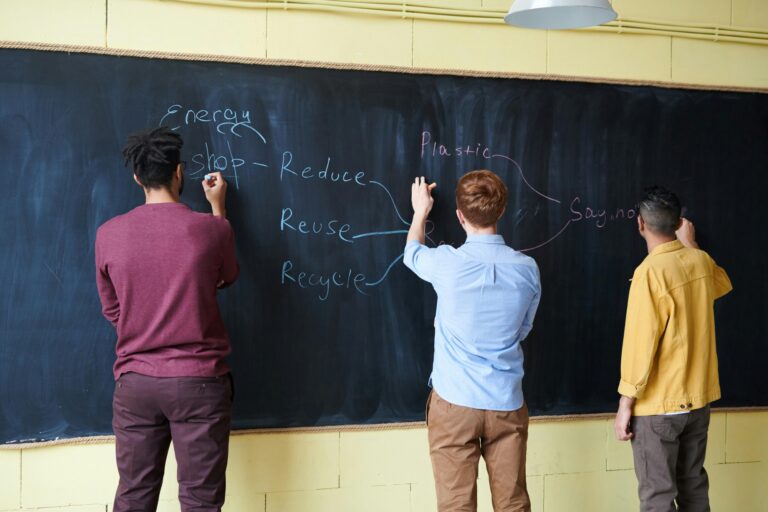 Students writing on the blackboard in the concept of 'top schools in Richmond'.